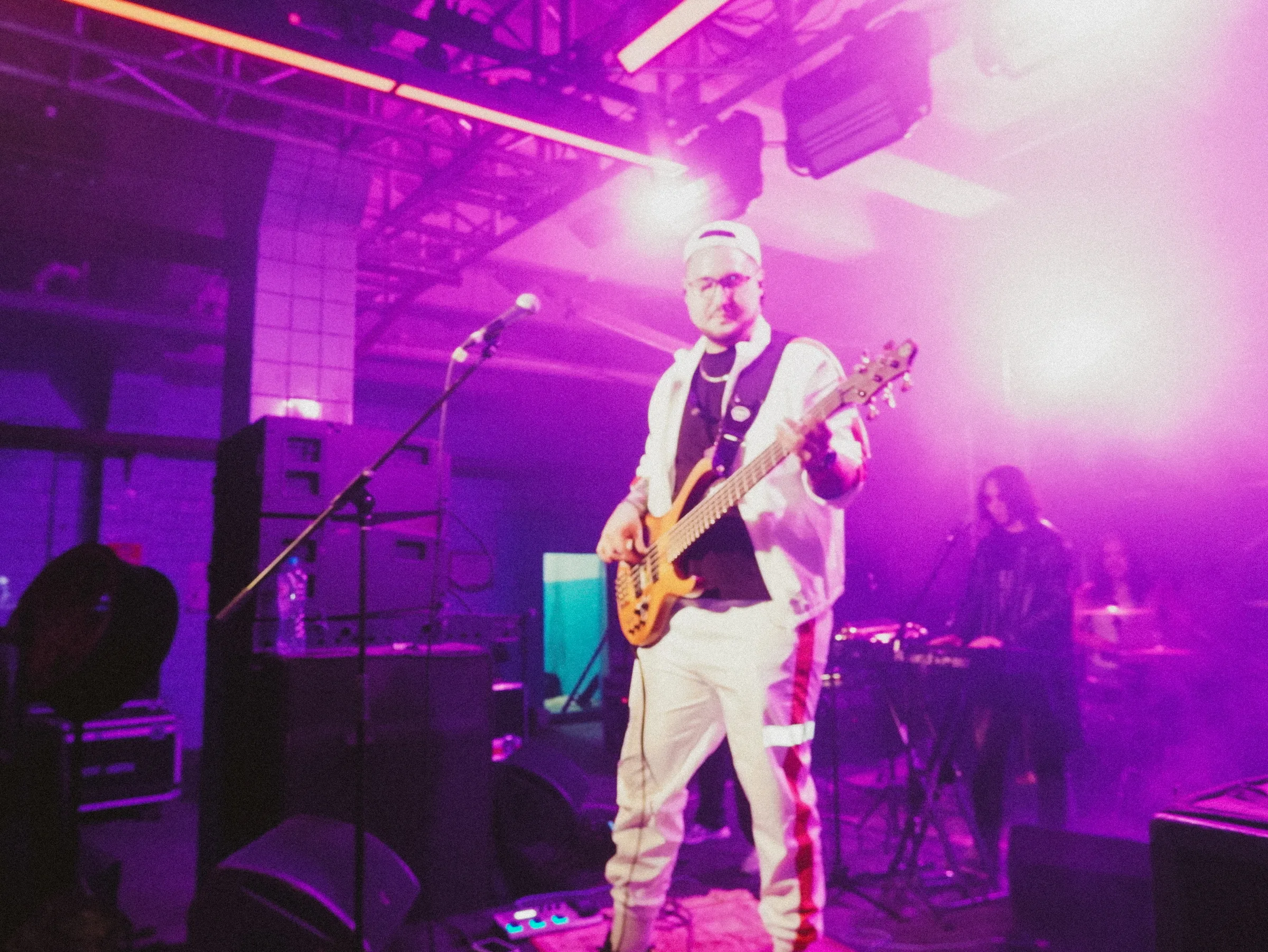 A singer with a guitar under the lights