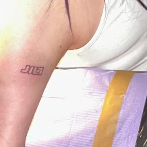 A JILT tattoo on an arm